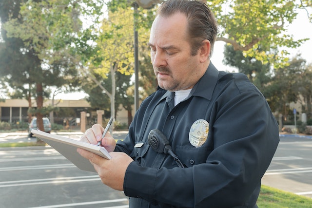 cop with paperwork